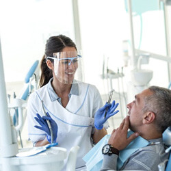a dentist performing a checkup on a patient
