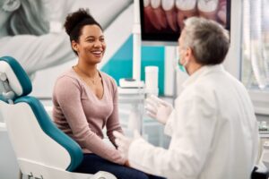 smiling patient and dentist talking